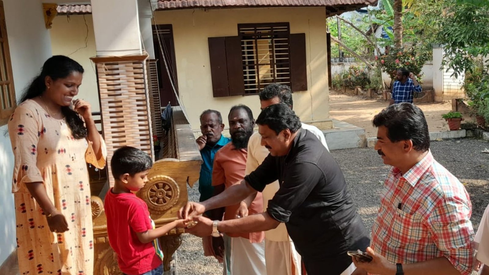 A family of Mariapally in Kottayam handing over the money as part of a fund collection drive organised by the residents for the treatment of the youth.