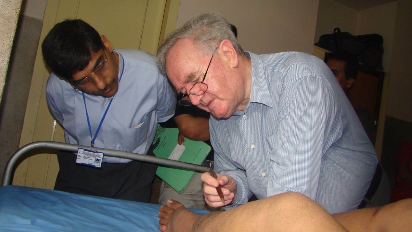 Institute of Applied Dermatology (IAD) Kerala Director Dr S R Narahari and his mentor Professor Terence Ryan of Oxford University, United Kingdom attending to a Lymphedema patient at IAD campus in Kasargod, Kerala.