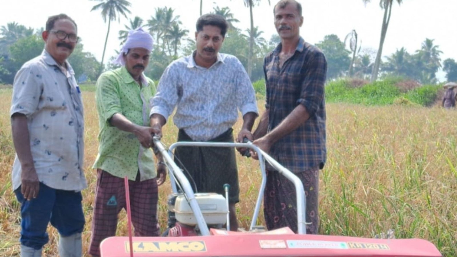 Farmers of Kumarakkom at the paddy field which they revived.