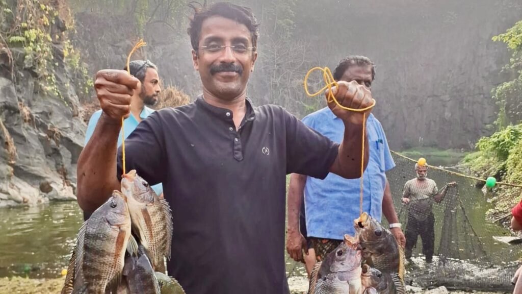 Kunjammu with the fish from his farm at Edathanattukara in Palakkad, Kerala.