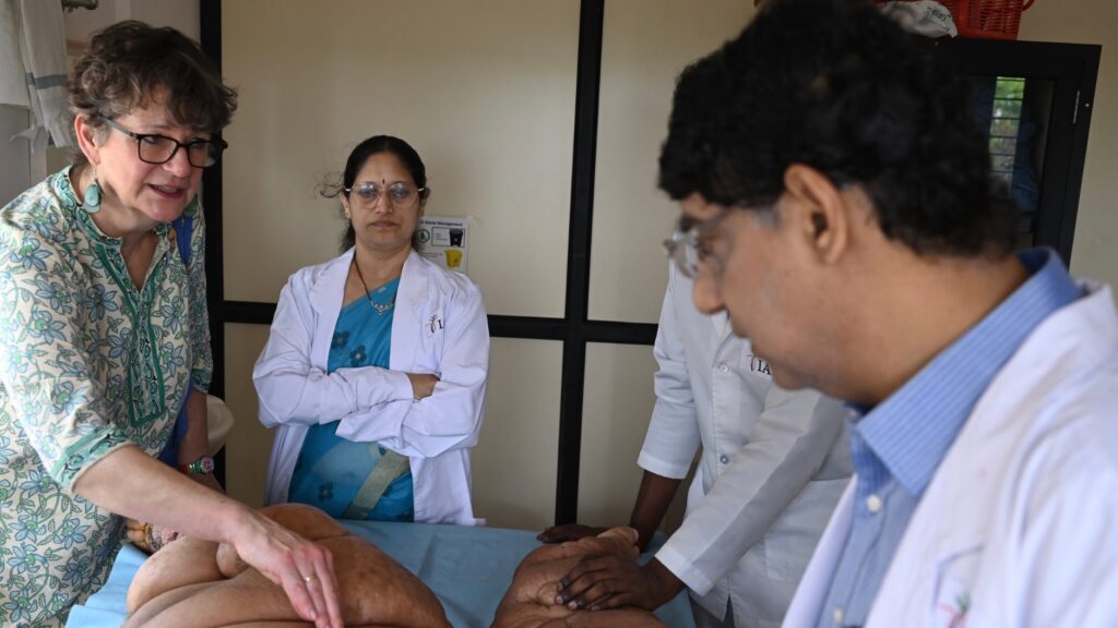 Professor Claire Fuller, Chair of the International Foundation of Dermatology and Consultant Dermatologist in NHS, Westminster, London, UK, and former Chair of the Skin NTD group, World Health Organisation (WHO along with IAD Director Dr S R Narahari and Senior Dermatologist Dr K S Prasanna attending to a patient.